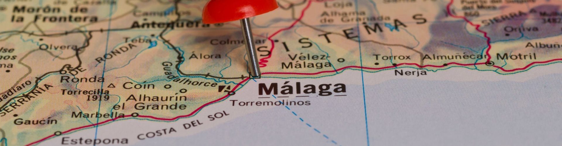 Málaga marked with red pushpin on map. Selected focus on Málaga and pushpin. Pushpin is in an angle.