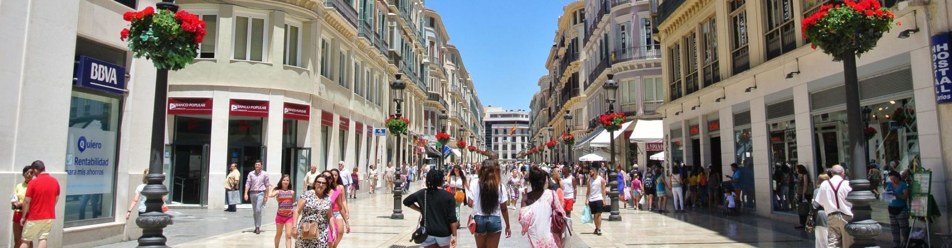 Malaga, Spain - July 1, 2014: The main pedestrian and shopping street in the center of Malaga, at the beginning of summer, on the first day of summer sales, which has attracted a large number of both locals and tourists to this Andalusian seaside resort.